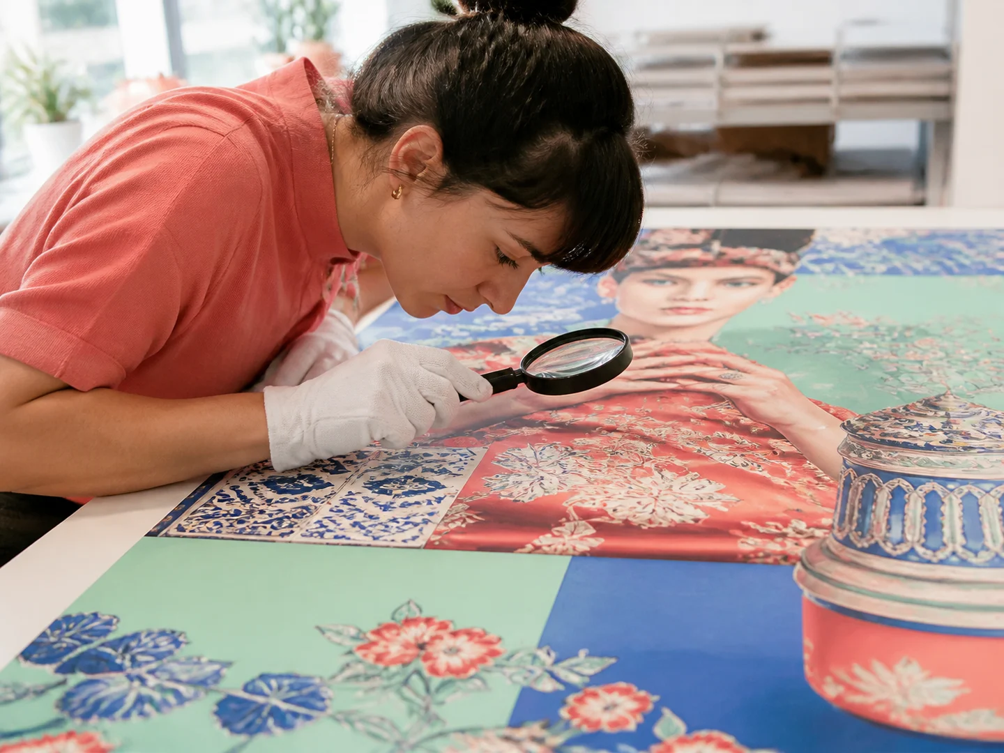 A printmaker inspecting difficult image details