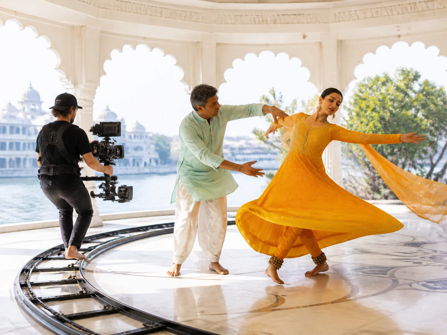 A choreographer guiding a dancer beside a tracking camera
